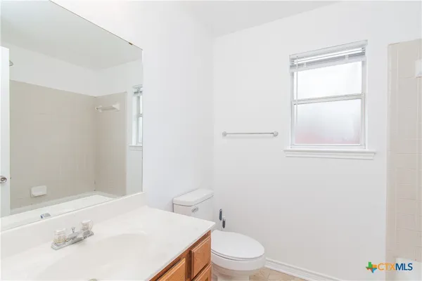 a white toilet sitting next to a bathroom sink