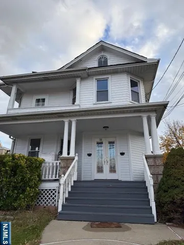 a front view of a house with wooden stairs