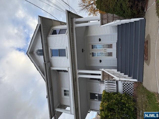 a front view of a house with wooden stairs
