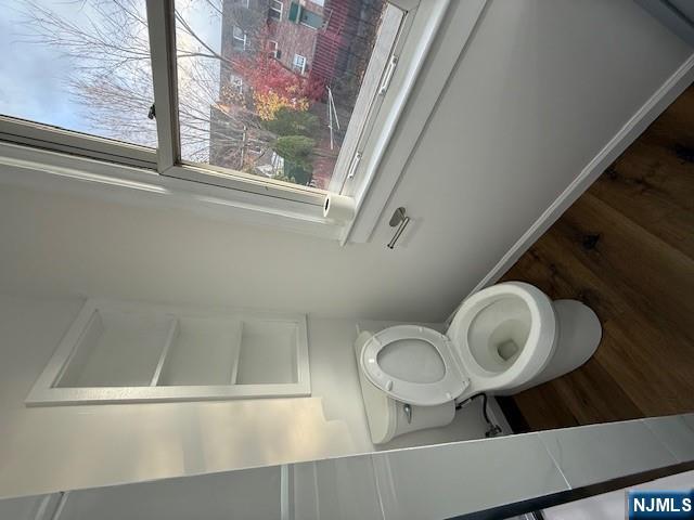 16 Central, Unit 2 Bergenfield, NJ 07621 - Photo 13 of 32 a toilet sitting in a bathroom next to a window