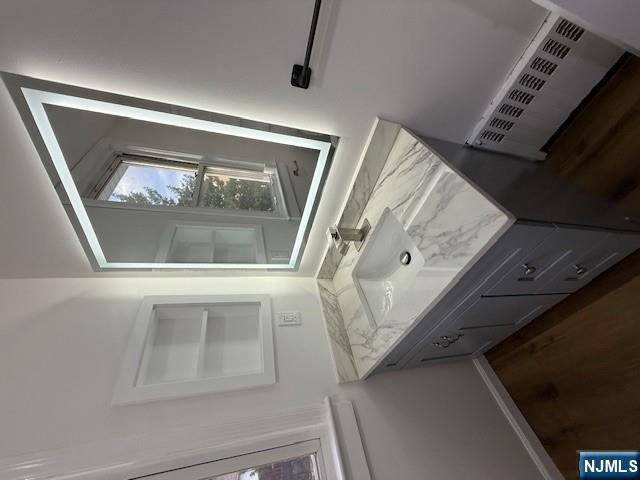 16 Central, Unit 2 Bergenfield, NJ 07621 - Photo 14 of 32 a bathroom with a granite countertop sink and a window