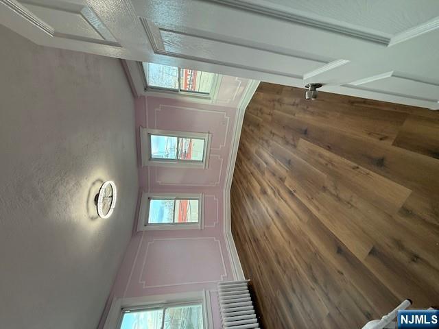 16 Central, Unit 2 Bergenfield, NJ 07621 - Photo 16 of 32 a view of an empty room with wooden floor and a window