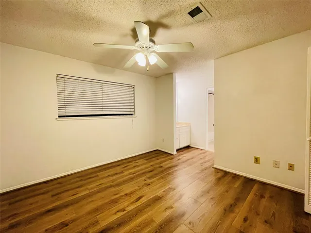 a view of a big room with wooden floor and closet area