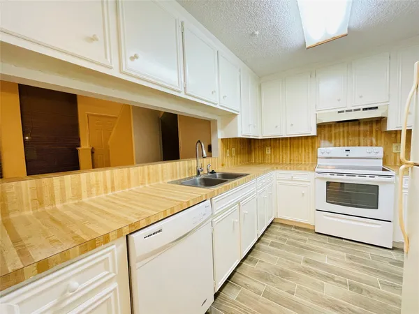a kitchen with stainless steel appliances granite countertop a sink and cabinets