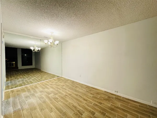 a bathroom with a granite countertop toilet sink and mirror