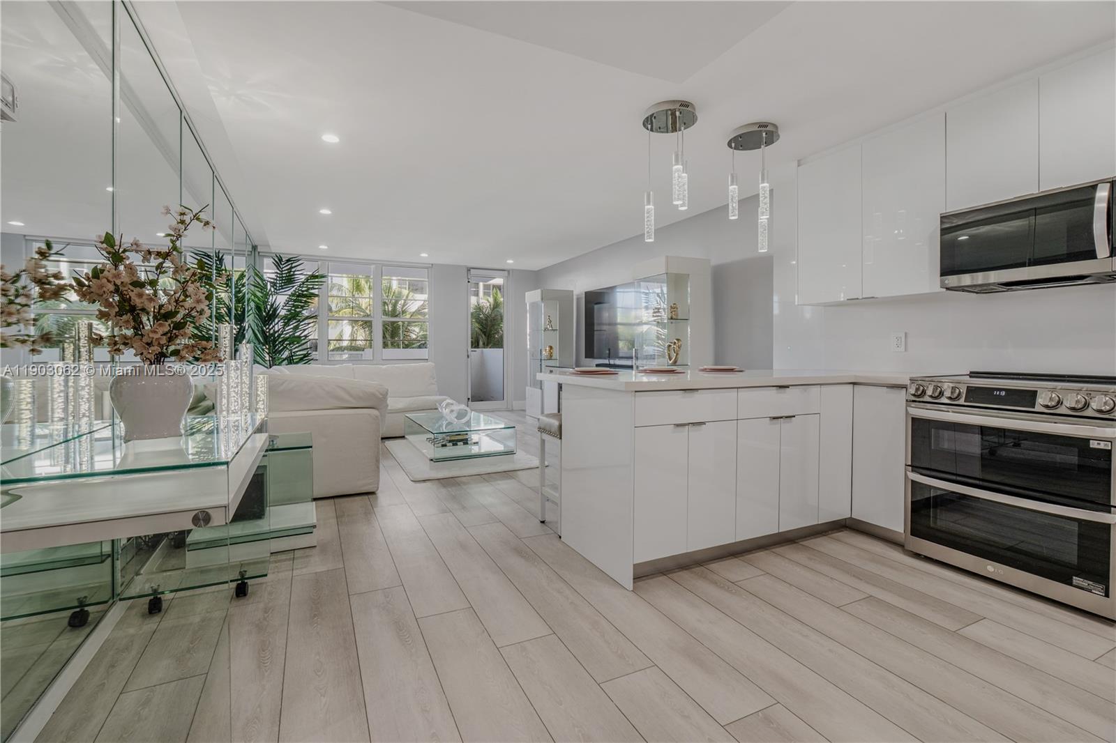 100 Lincoln Road, Unit 323 Miami Beach, FL 33139 - Photo 12 of 59 a kitchen with a sink stainless steel appliances and cabinets