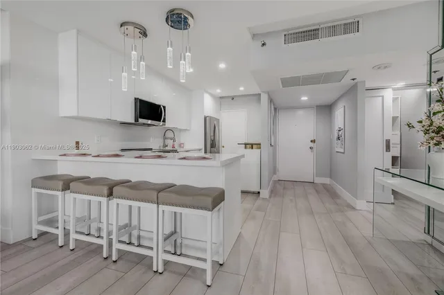 a kitchen with stainless steel appliances a stove sink and microwave