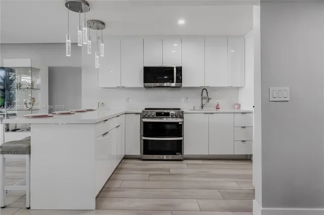 a kitchen with a refrigerator stove and microwave