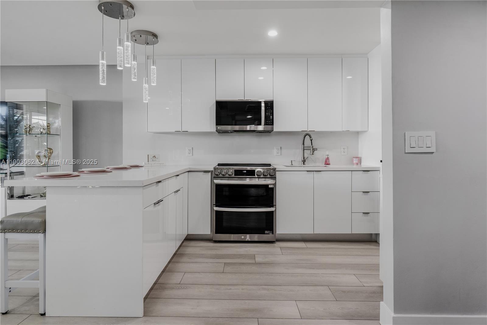 100 Lincoln Road, Unit 323 Miami Beach, FL 33139 - Photo 21 of 59 a kitchen with stainless steel appliances a stove sink and microwave