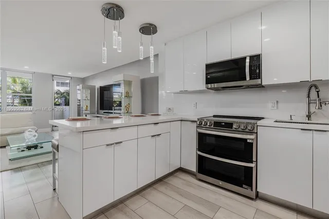 a kitchen with a sink stove top oven and cabinets