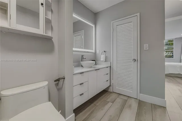 a spacious bedroom with a bed and a large window with outer view