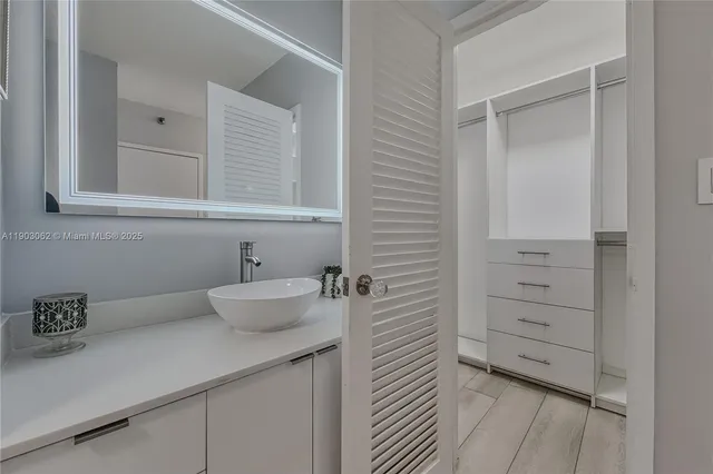 a spacious bedroom with a bed and a wooden floor