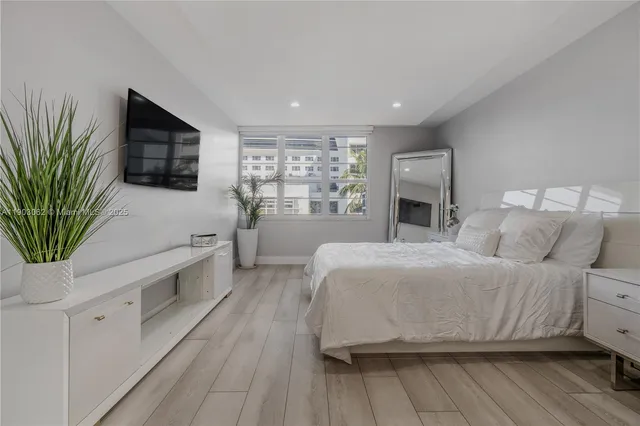 a bedroom with a bed and a flat screen tv