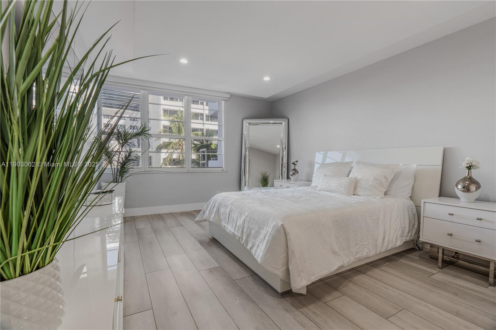 100 Lincoln Road, Unit 323 Miami Beach, FL 33139 - Photo 31 of 59 a spacious bedroom with a bed and a large window with outer view