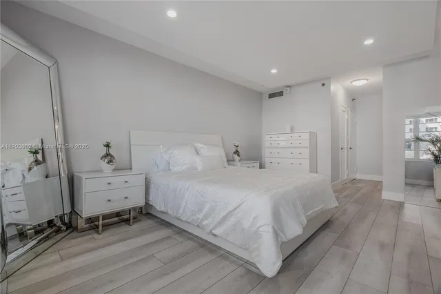 a bed sitting in a bedroom next to a window