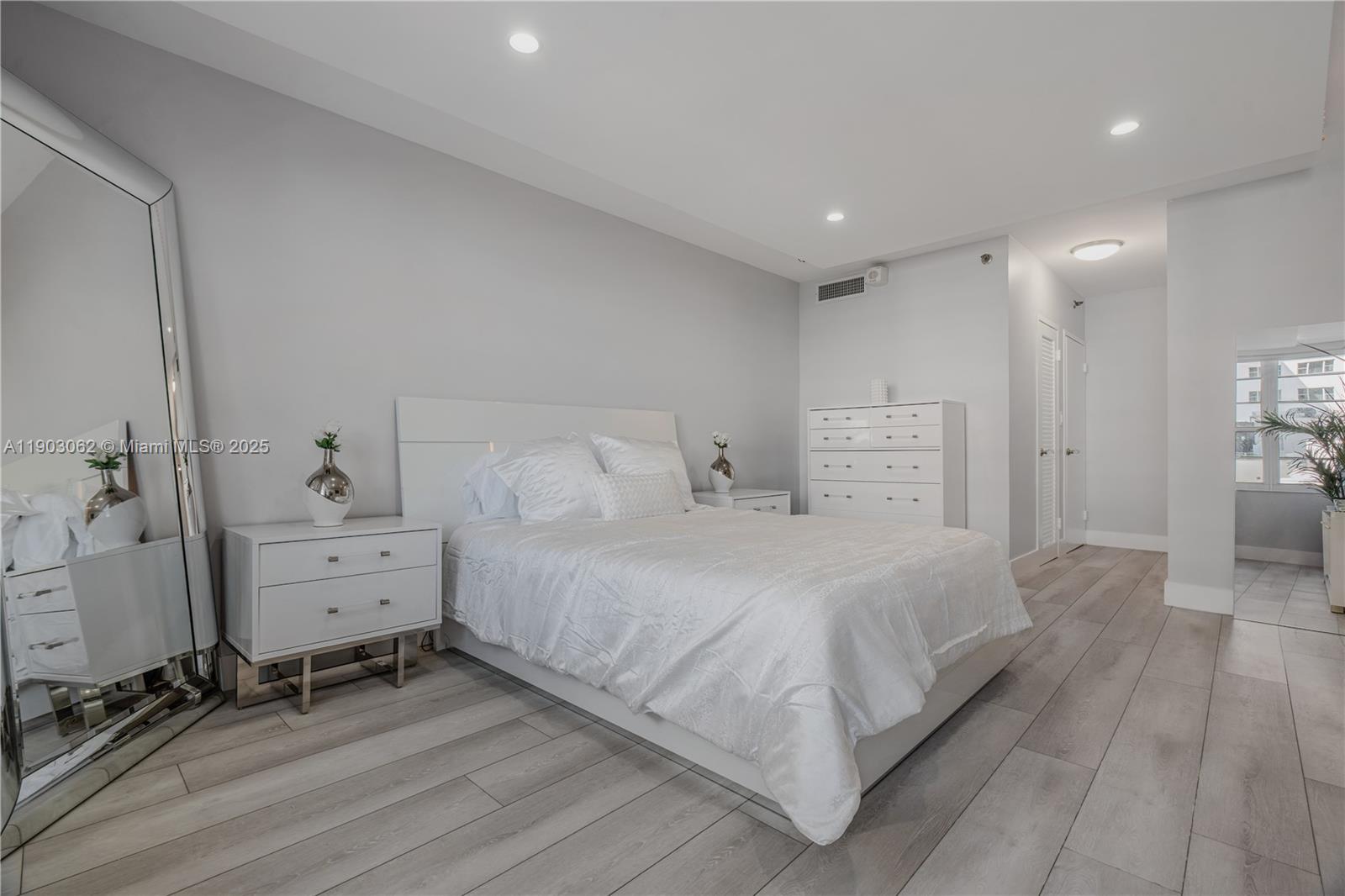 100 Lincoln Road, Unit 323 Miami Beach, FL 33139 - Photo 32 of 59 a spacious bedroom with a bed and a wooden floor