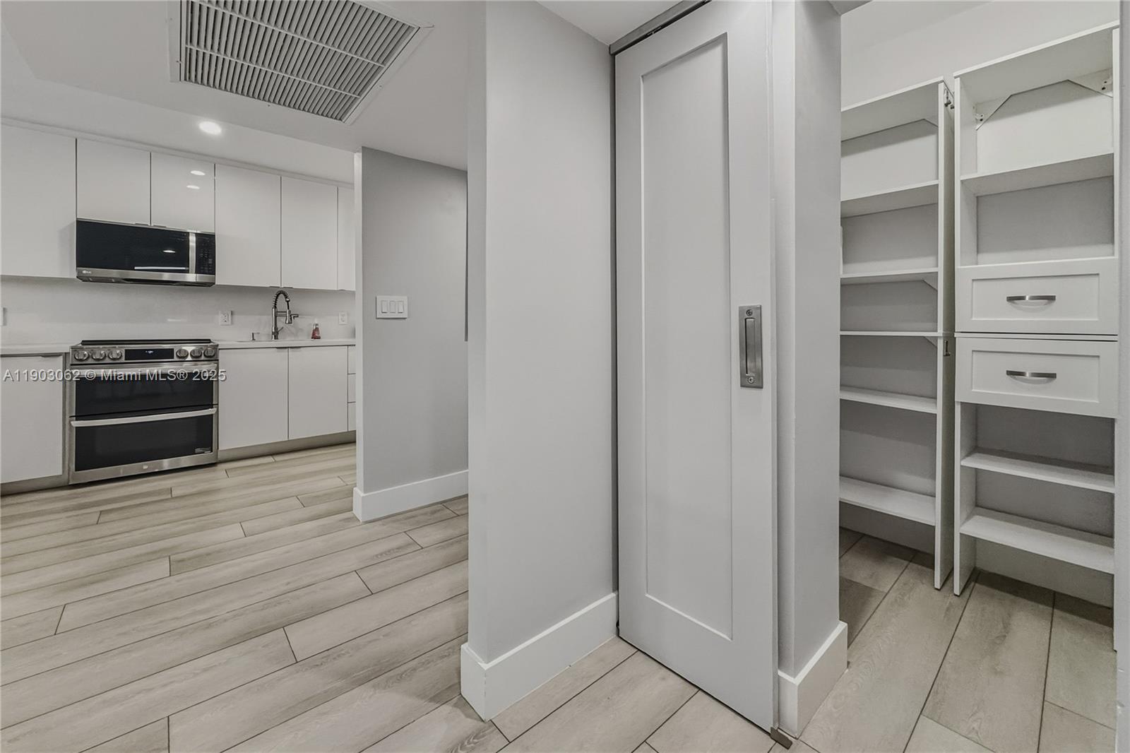100 Lincoln Road, Unit 323 Miami Beach, FL 33139 - Photo 7 of 59 a kitchen with granite countertop cabinets and steel stainless steel appliances