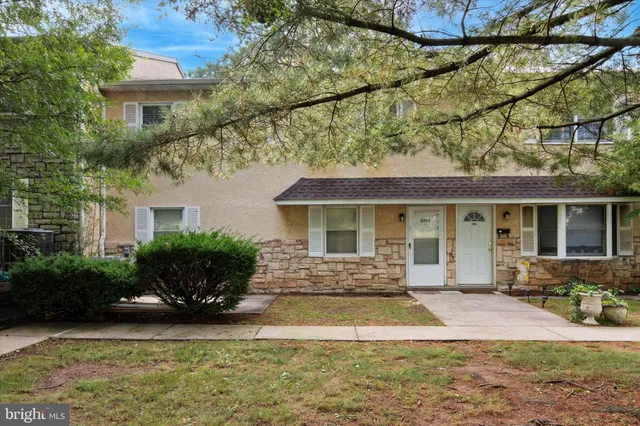 a front view of a house with yard and seating space