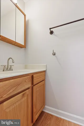 a view of a closet with wooden floor
