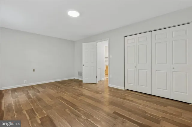 a view of an empty room and wooden floor