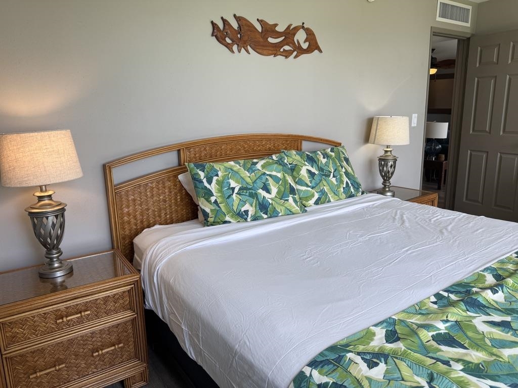 4327 Lower Honoapiilani Road, Unit 201B Lahaina, HI 96761 - Photo 18 of 26 a bed sitting in a bedroom next to a lamp