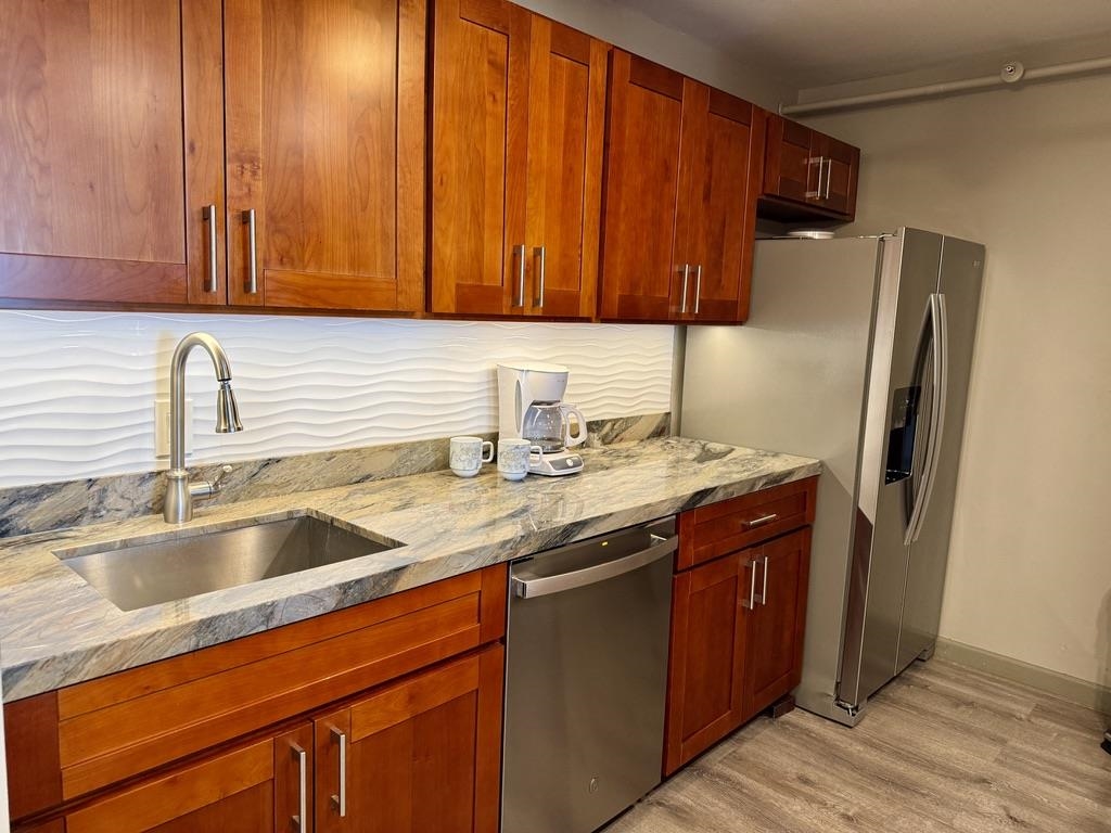 4327 Lower Honoapiilani Road, Unit 201B Lahaina, HI 96761 - Photo 2 of 26 a kitchen with stainless steel appliances granite countertop a sink refrigerator and cabinets