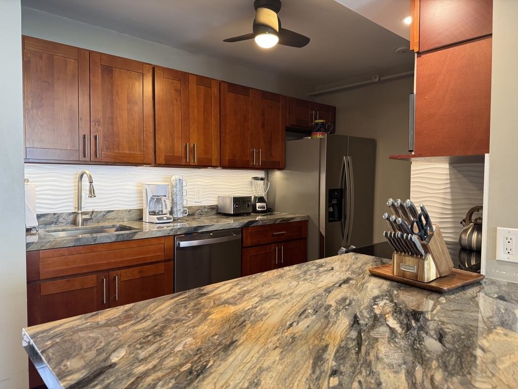 4327 Lower Honoapiilani Road, Unit 201B Lahaina, HI 96761 - Photo 4 of 26 a kitchen with stainless steel appliances granite countertop a sink refrigerator stove and microwave