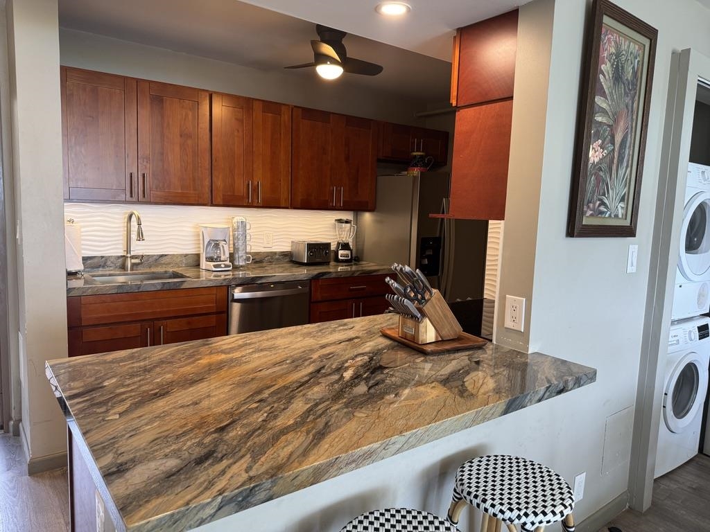4327 Lower Honoapiilani Road, Unit 201B Lahaina, HI 96761 - Photo 5 of 26 a kitchen with a sink a stove and cabinets