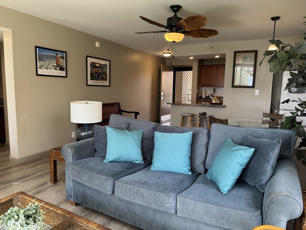 4327 Lower Honoapiilani Road, Unit 201B Lahaina, HI 96761 - Photo 9 of 26 a living room with furniture and a chandelier