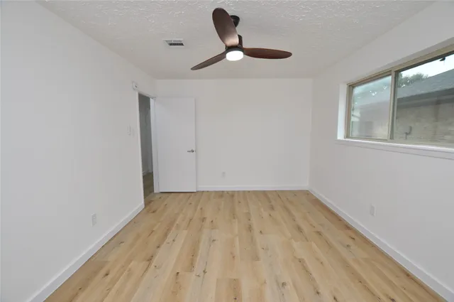 a view of room with hardwood floor and window