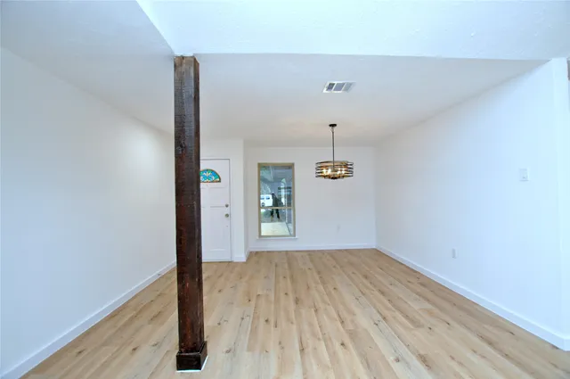 a view of hallway with wooden floor