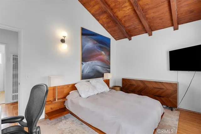 a bedroom with a bed and a chair