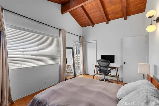 a bedroom with furniture and a wooden floor