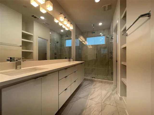a bathroom with a sink a toilet and mirror
