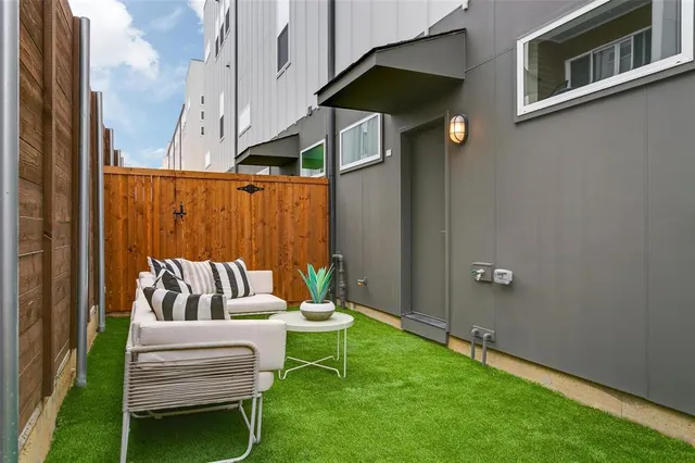 a view of a room with wooden floor and a ceiling fan