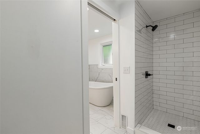 a bathroom with a granite countertop shower