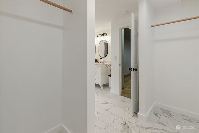 a bathroom with a granite countertop shower and a sink