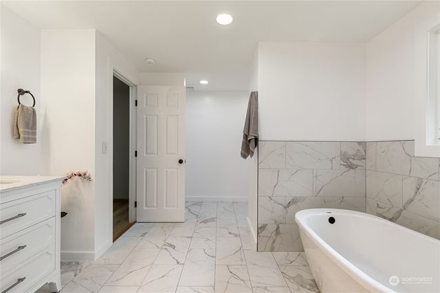 a bathroom with a bathtub and a shower