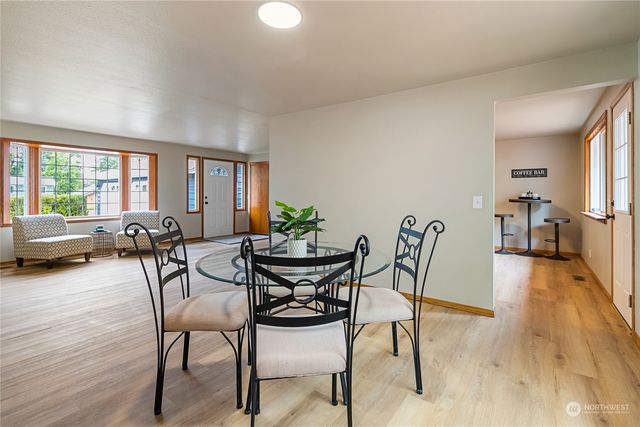a view of a dining room with furniture and a large window