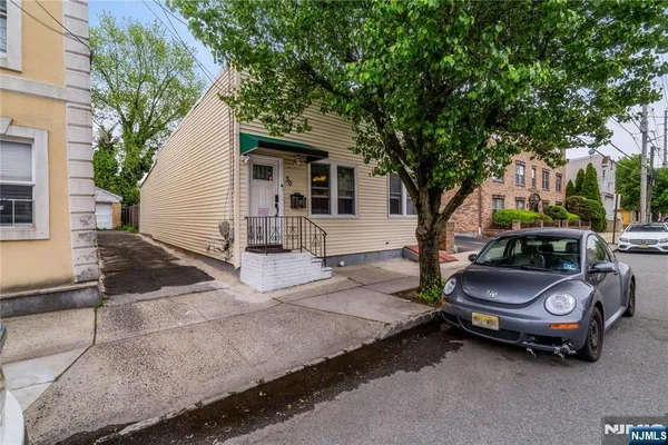 a couple of cars parked in front of a house