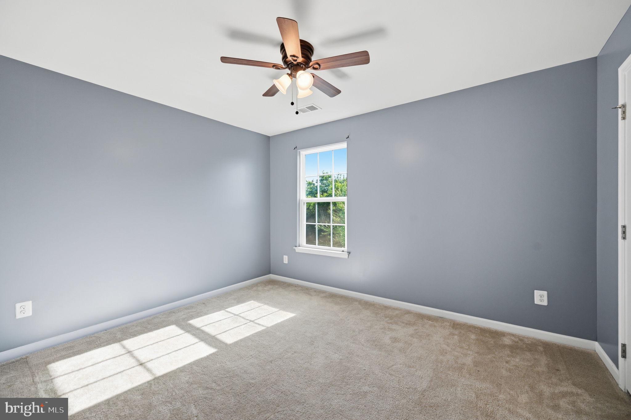 687 Blossom Tree Road Culpeper, VA 22701 - Photo 14 of 31 an empty room with a window and a fan
