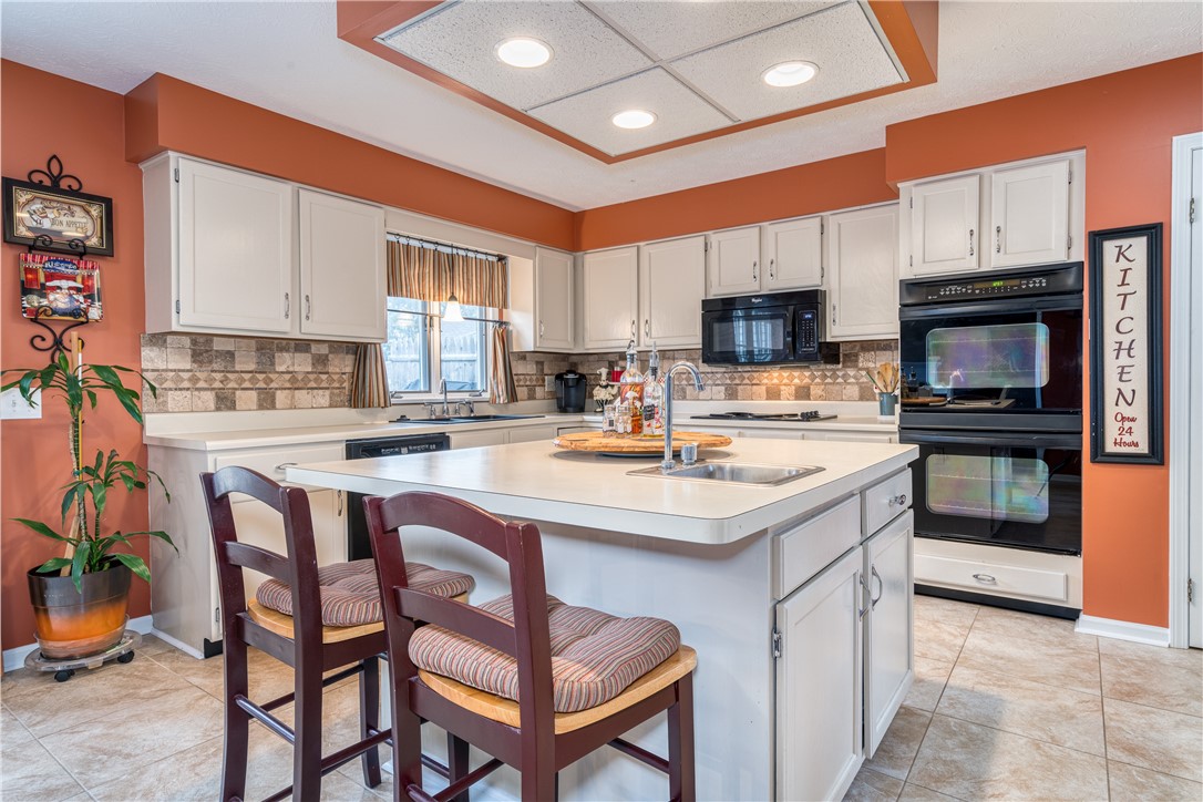 7 Bardney Circle Perinton, NY 14450 - Photo 9 of 38 Breakfast bar seating at large island!! Great prep