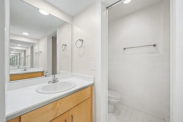 a bathroom with a sink toilet and shower