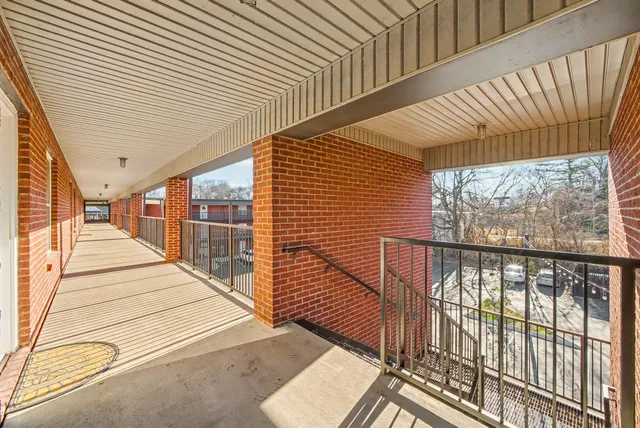a view of a balcony with wooden floor