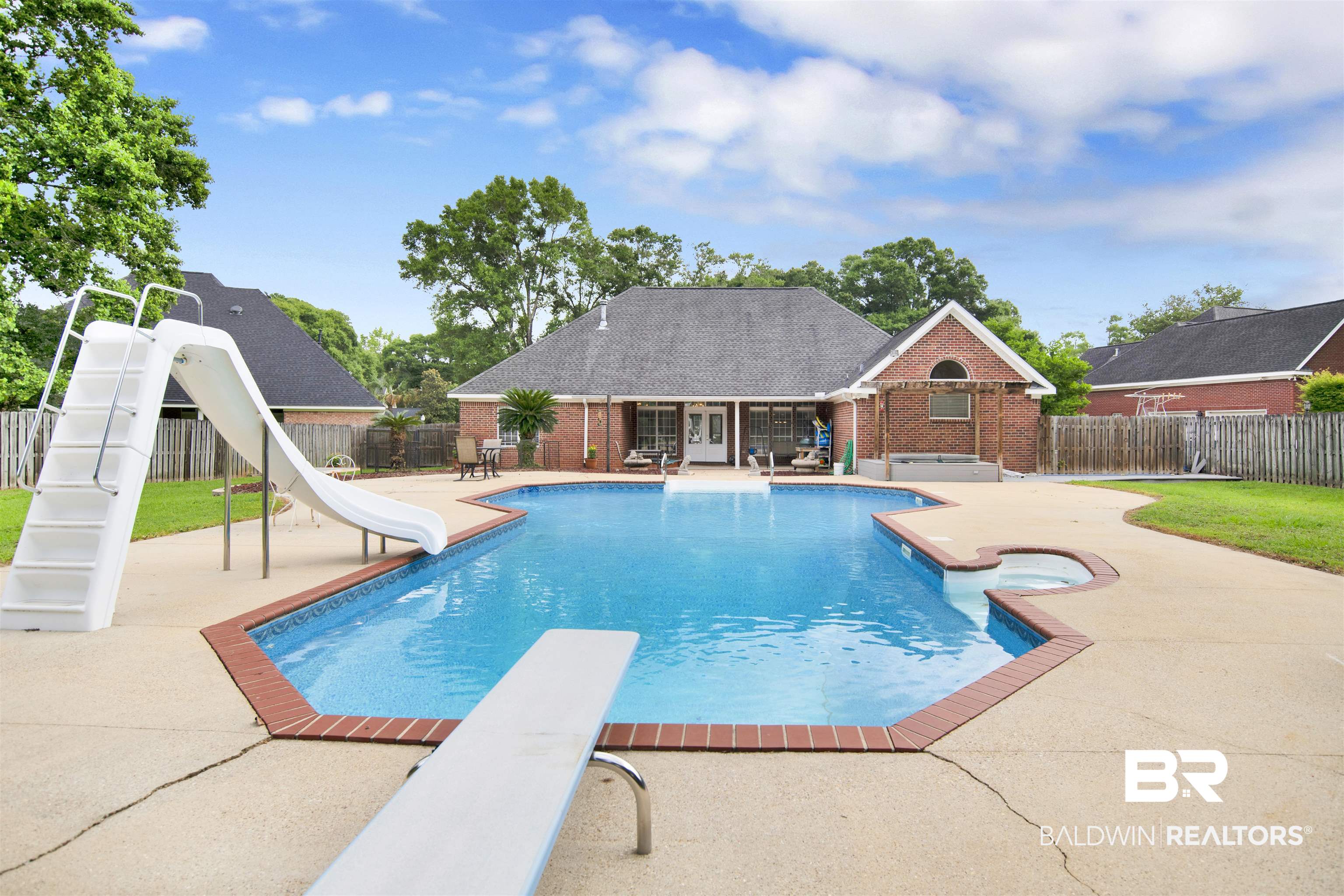 8847 Dawes Lake Road South Mobile, AL 36619 - Photo 39 of 47 Expansive backyard featuring a large swimming pool with an integrated spa, diving board, and waterslide