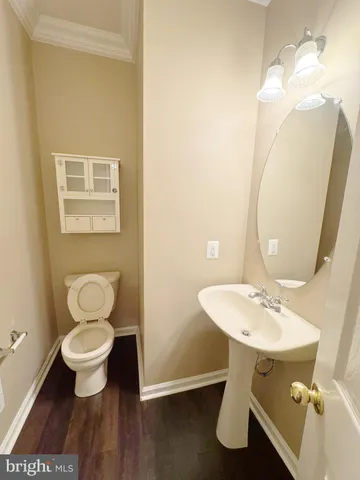 a bathroom with a toilet sink and a mirror