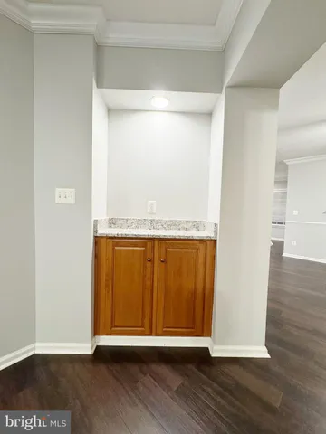 an empty room with wooden floor and a window