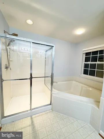 a spacious bathroom with a granite countertop sink mirror and