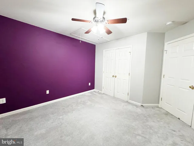 a view of a livingroom with a ceiling fan and window
