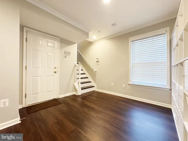 a view of wooden floor and windows in a room